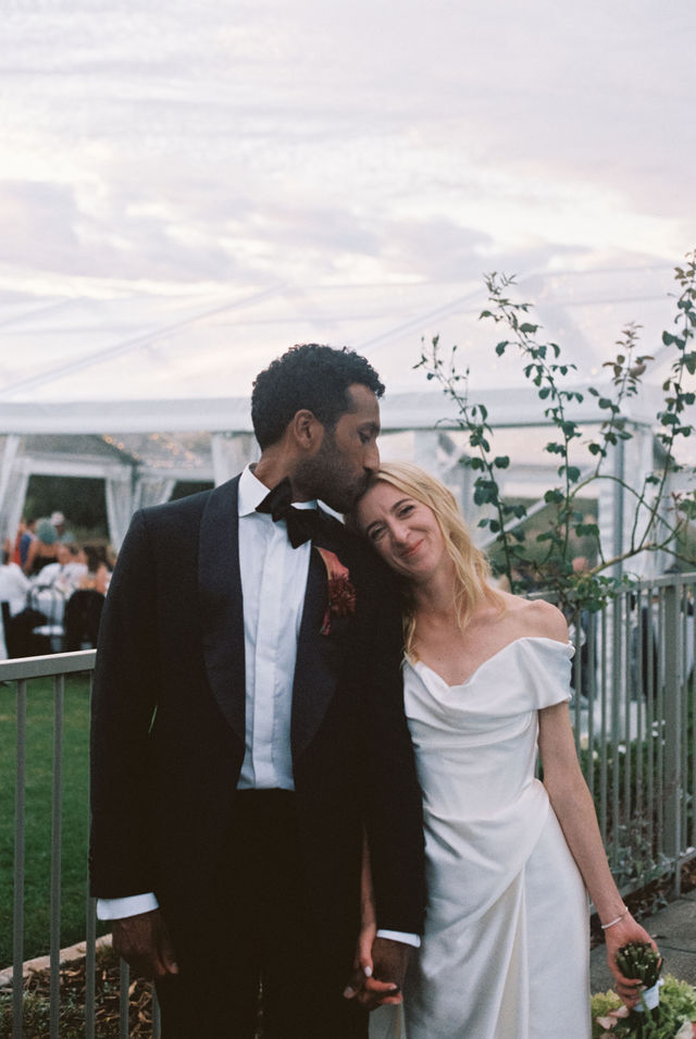 Couple embracing at dusk on their wedding day, shot on 35mm film