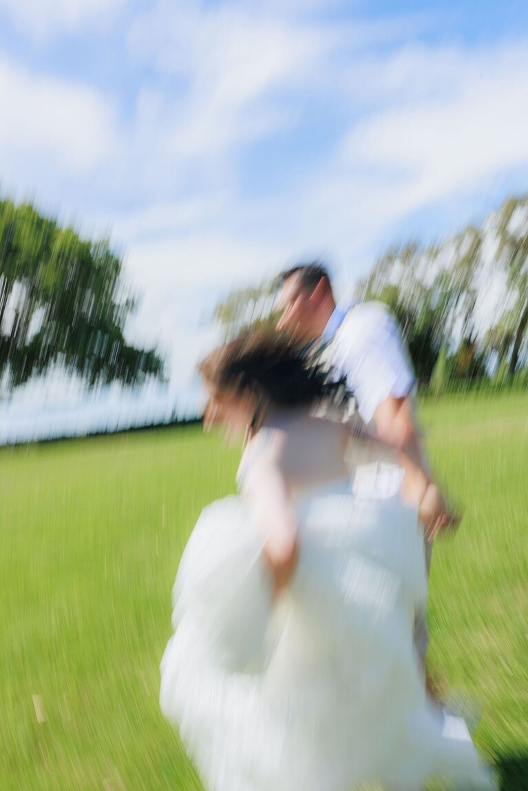 Bride spinning in a field, motion blur
